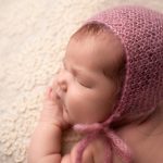 newborn baby shoot studio portrait pink bonnet