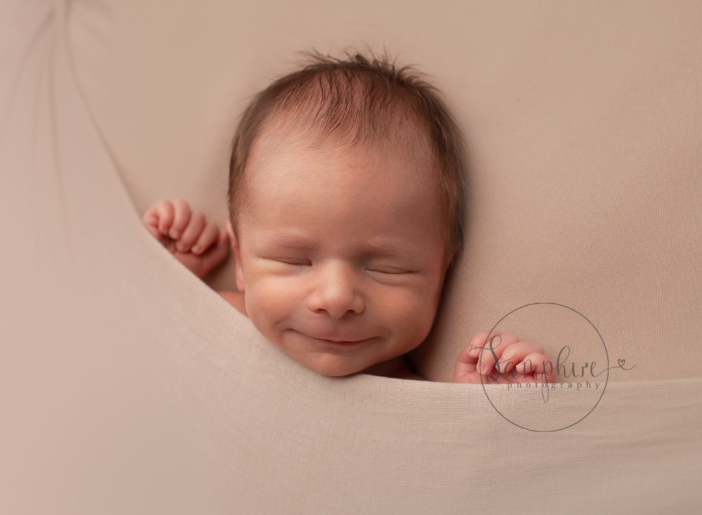 photograph your newborn baby at home smile Samphire Photography Sussex