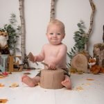 Happy boy getting stuck into his Cake smash Worthing