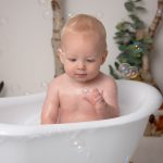 At a cake smash Worthing this little boy is catching a bubble