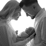 parents cradling newborn baby