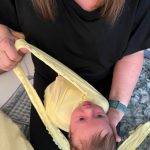 journey of a newborn image showing the baby being wrapped