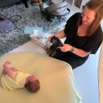 journey of a newbornimage looking at the back of the camera to check the shot