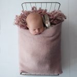 Baby girl asleep in a metal bed with her cuddly toy showing baby portraits billinghurst by samphire photography