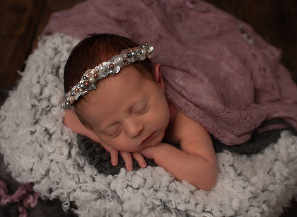 Baby girl wearing sequin headband by Samphire Photography newborn photographer Storrington