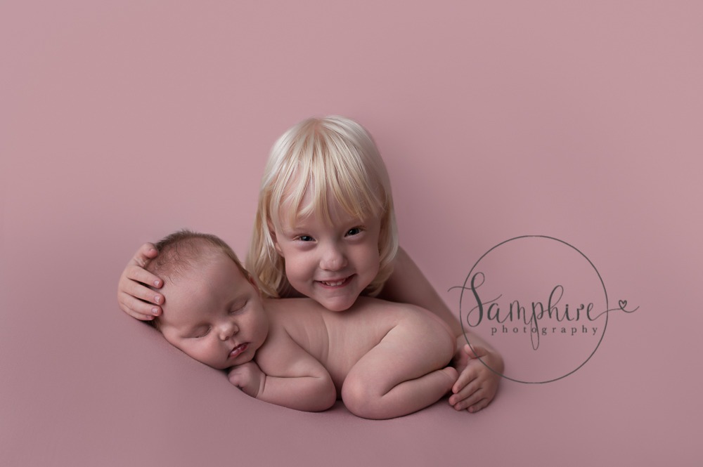 Newborn baby girl with big sister