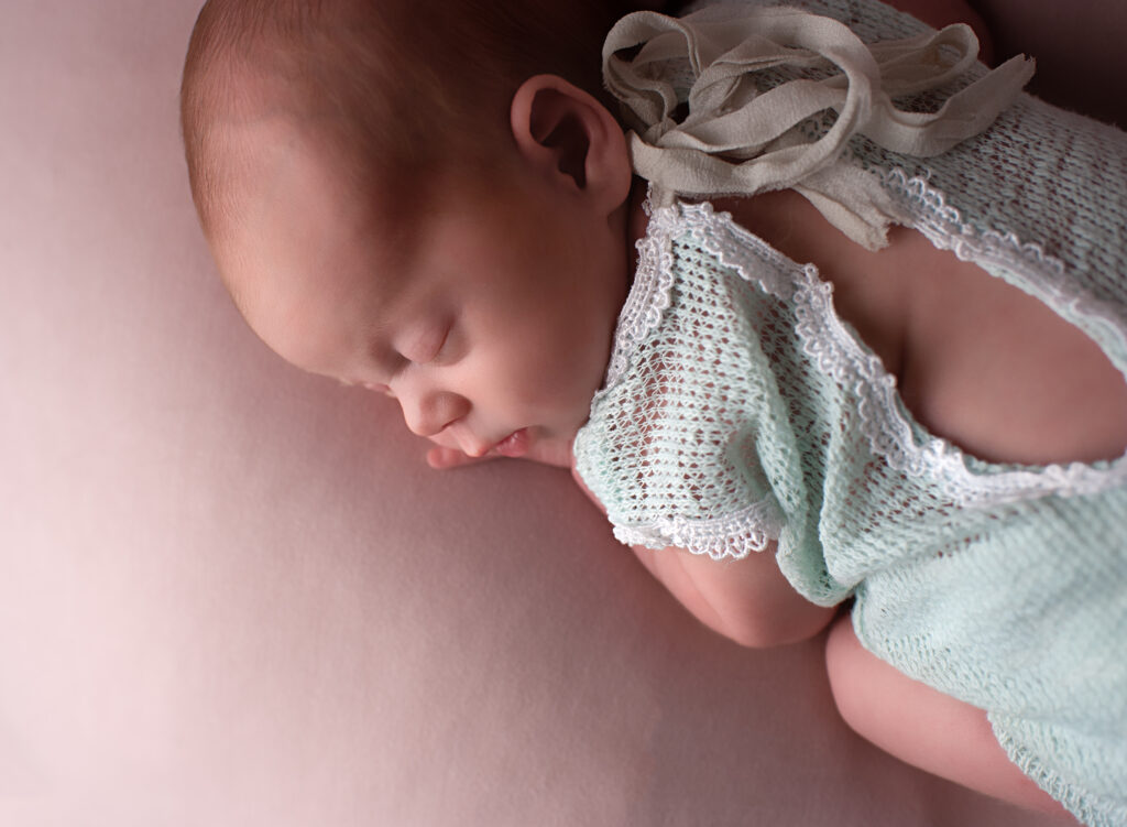 Studio photograph of sleeping baby girl by newborn photographer Billingshurst Samphire Photography