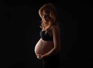pregnant woman showing why maternity photographs important