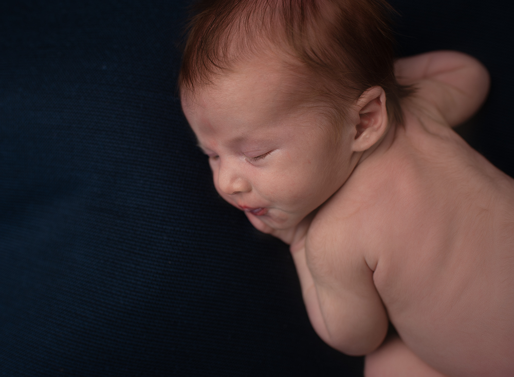 Baby boy asleep during newborn photoshoot Sussex