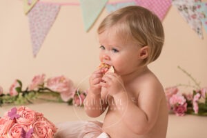 Cake Smash eating cake chocolate pink bunting photo sussex