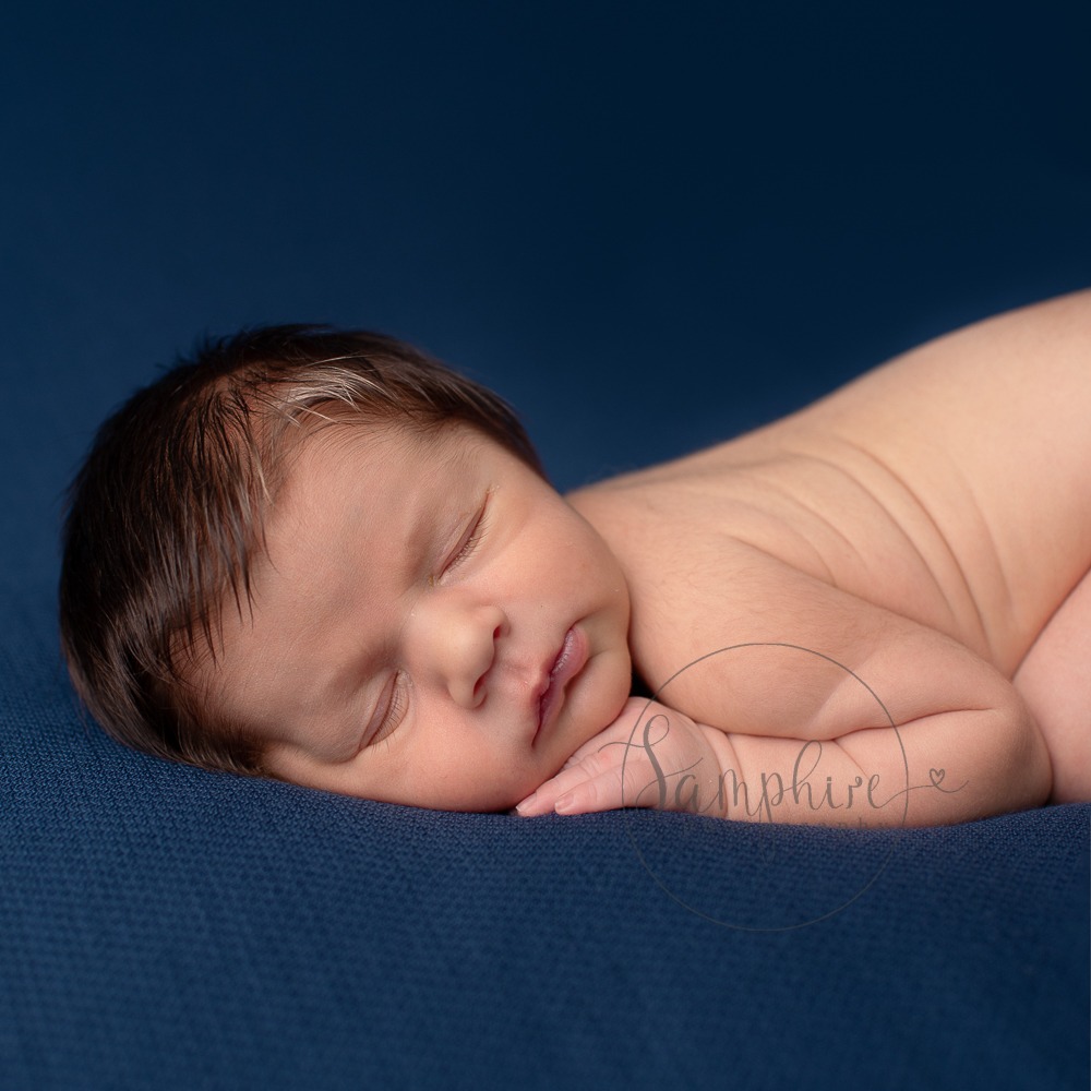 New baby portraits West Sussex blue background Samphire Photography