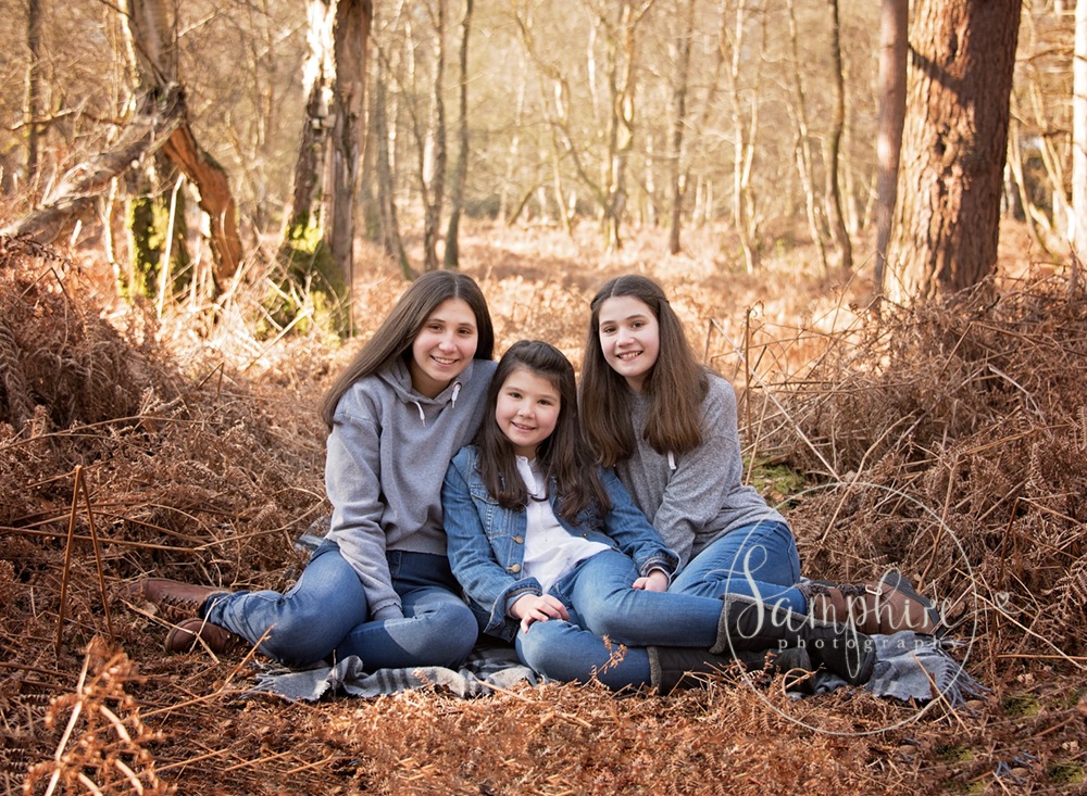 sisters smile in autumn woodland portraits Sussex