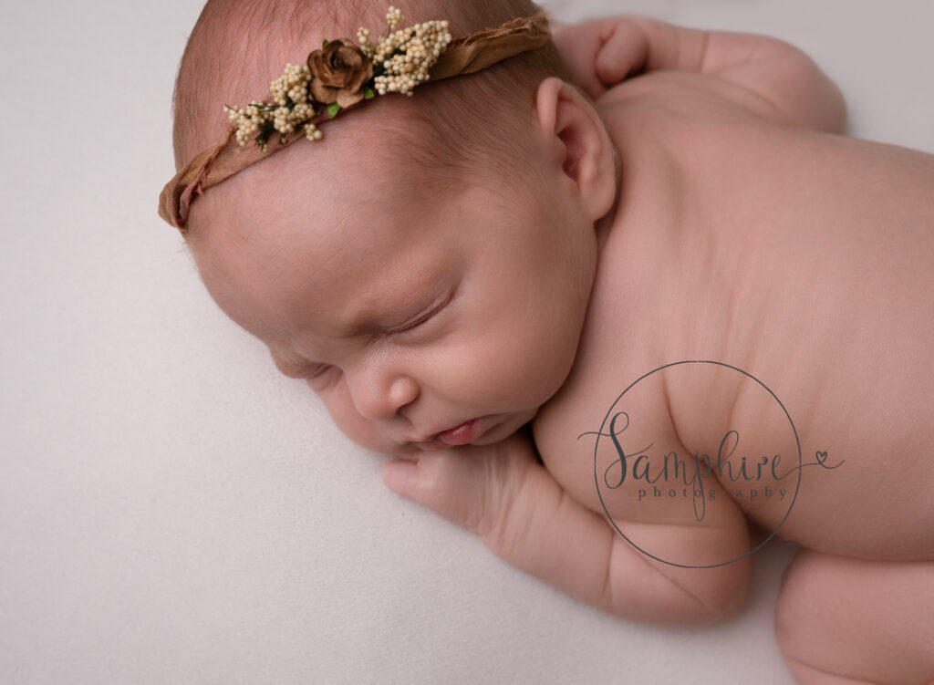 sleeping newborn wearing headband