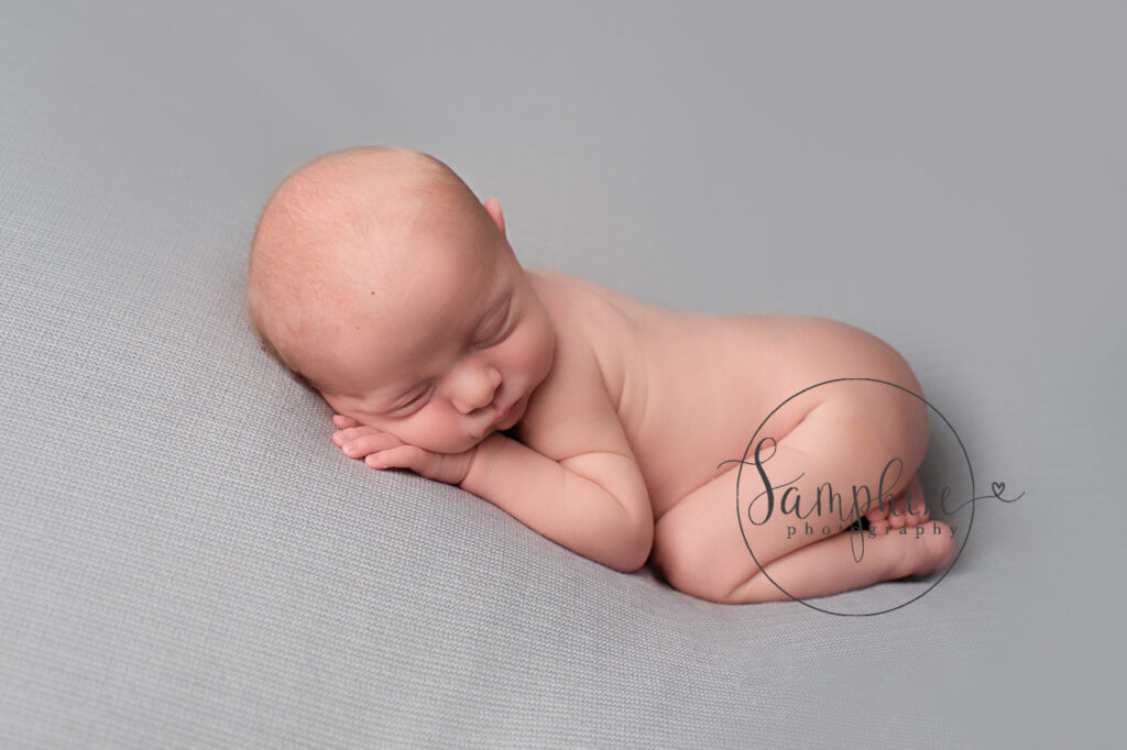 baby boy asleep on grey fabric