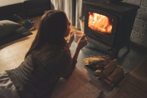 woman by log burner
