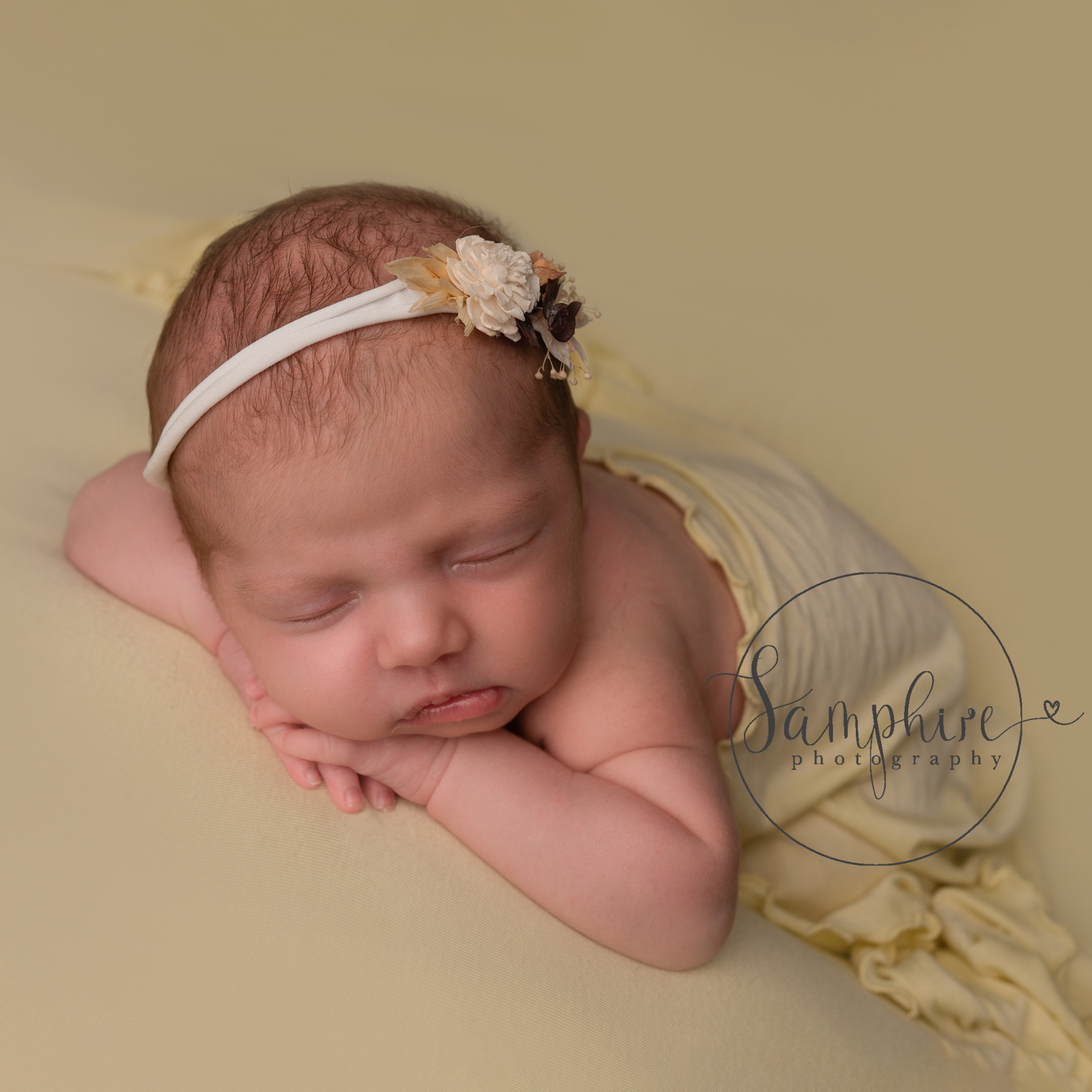 newborn baby girl sleeping on yellow by samphire