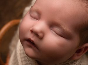 Close up photograph of sleeping newborn baby face