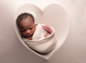 Swaddled baby sleeping in heart