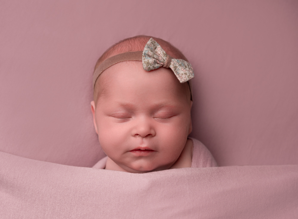 Baby girl asleep wearing bow headband
